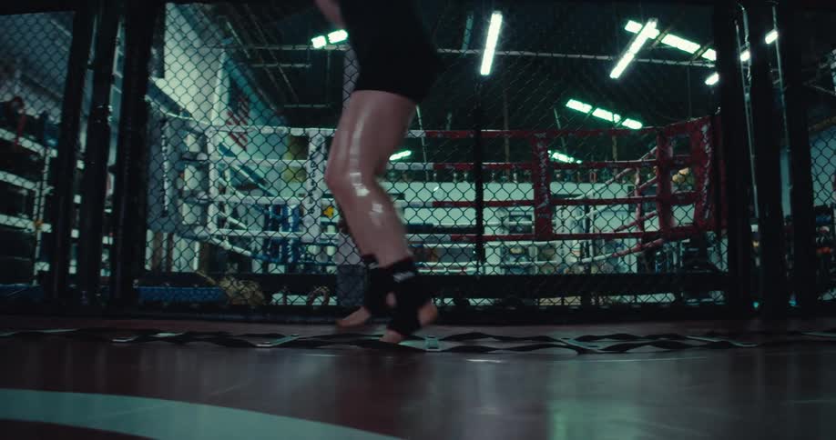 A person performs agility ladder drills in a gym surrounded by various exercise equipment