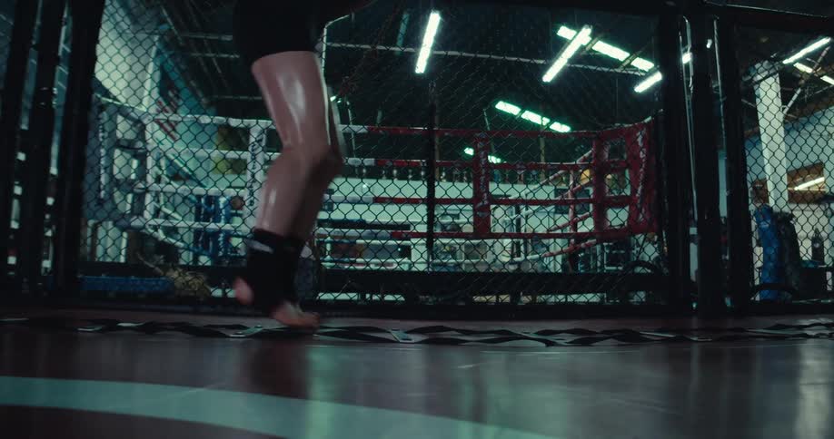 Woman performs an agility exercise in the area near a boxing gym