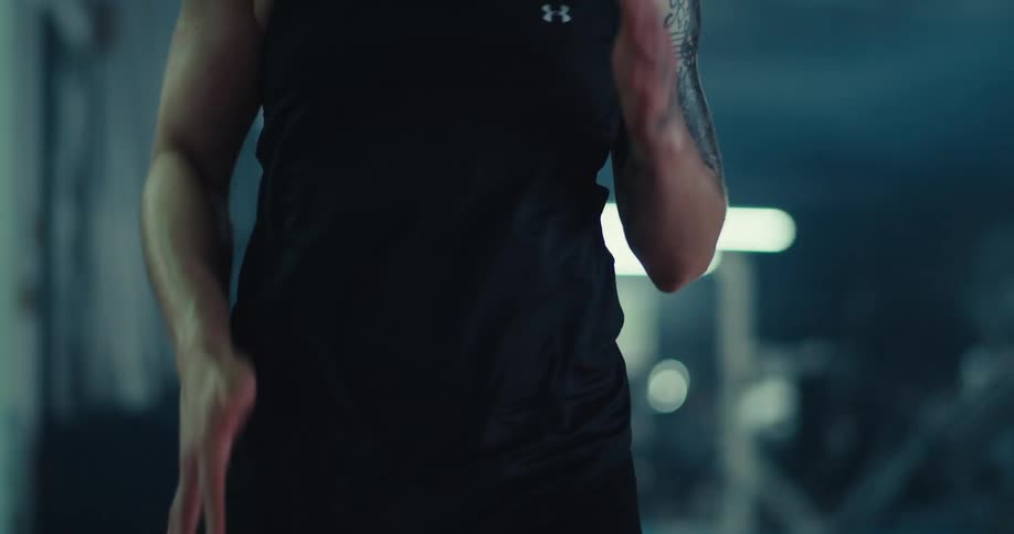 The woman in black is doing high knees and coming towards the camera