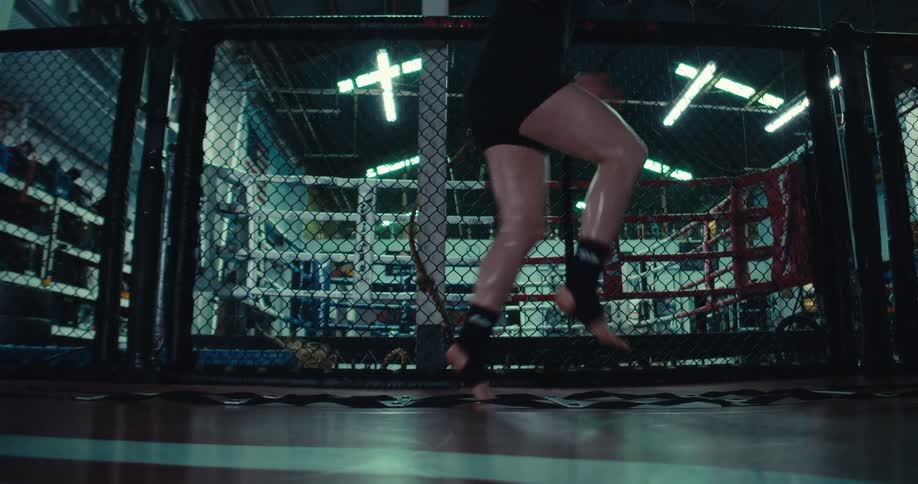 A person performs agility ladder drills in a gym surrounded by various exercise equipment