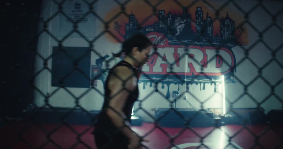 Concentrated woman warming up in a boxing gym environment