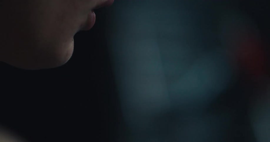 Side portrait of a woman taking a deep breath