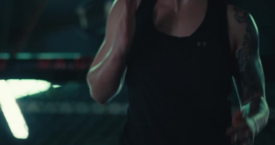 Body of a woman in an indoor environment warming up