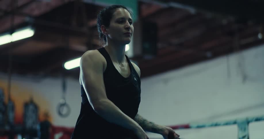 Woman jumps rope while exercising at a gym