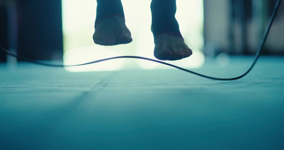 Close up of a persons feet jumping rope