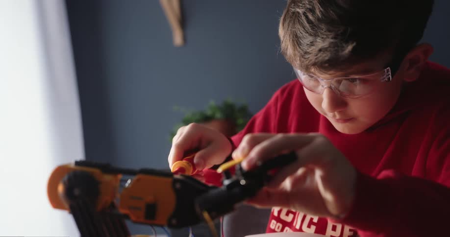 A footage of a boy working on a robotic toy