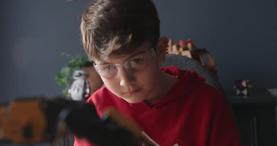 The robotic arm slowly lifts the small block