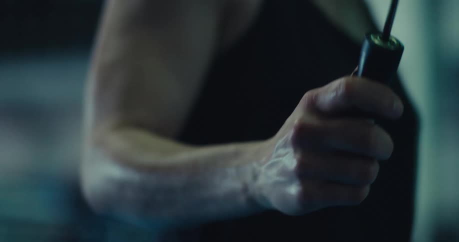 Close up of sweaty persons hands jumping rope