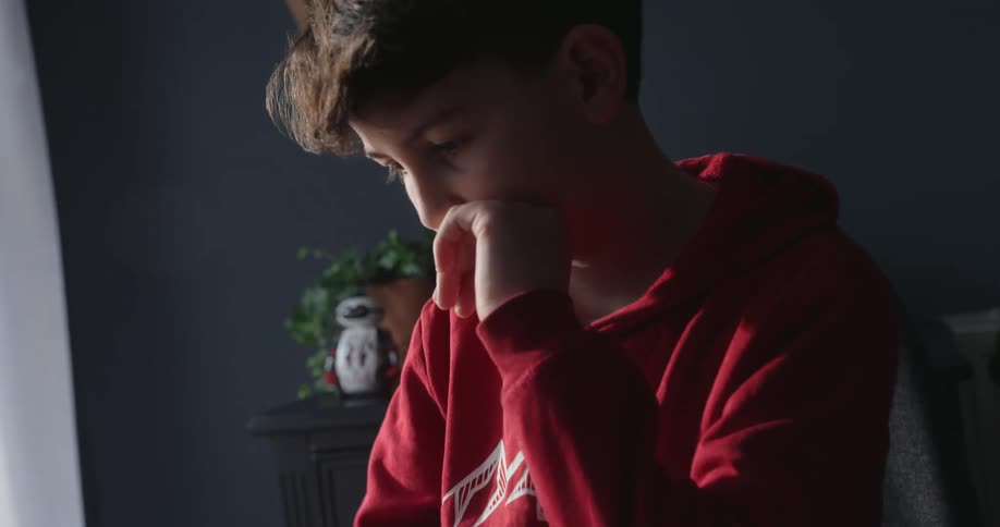 A footage of a boy typing on a laptop