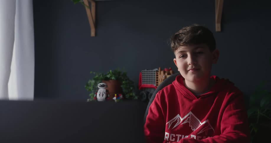 A footage of a boy writing on a desk