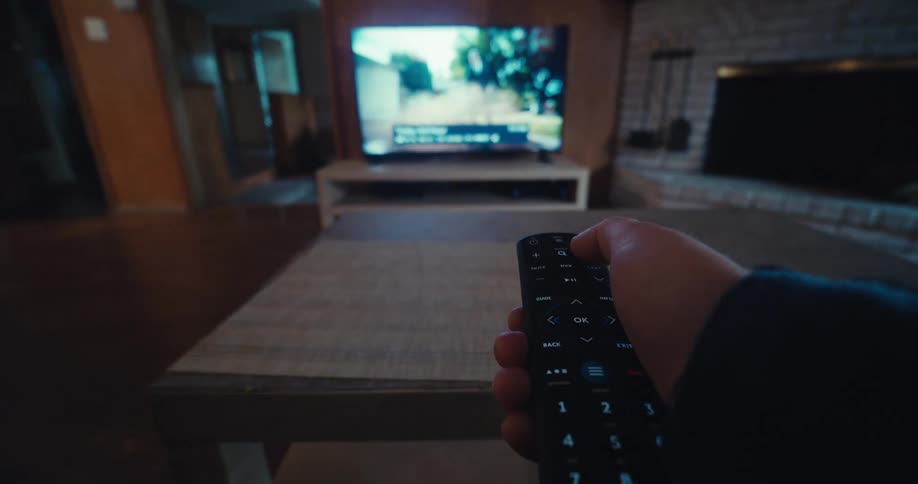 Point of view placing tv remote control on coffee table