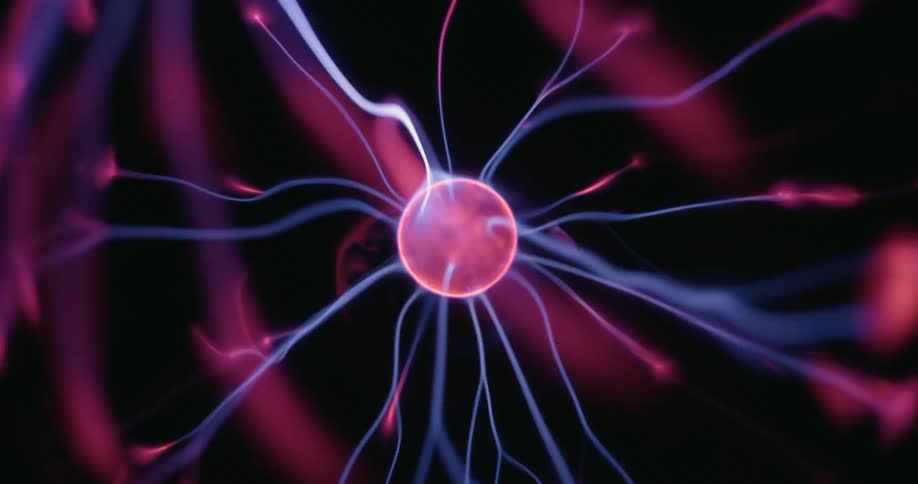 Neon arcs swirl outward from a central plasma sphere in a mesmerizing pattern flickering across a dark background as radiant electric threads connect each vibrant tendril in a luminous display