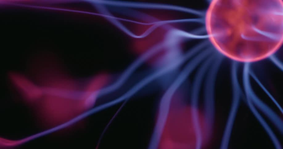 A luminous plasma orb is partially visible as swirling arcs of neon color flicker across a black background with each vibrant tendril extending from the orbs glowing center in a mesmerizing display of dancing light
