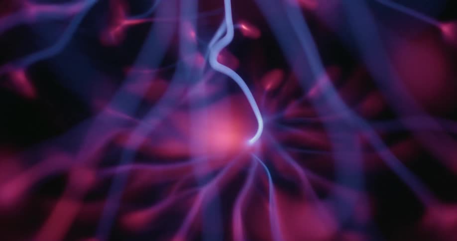 A plasma ball shows vibrant tendrils of purple and blue light radiating from a central point