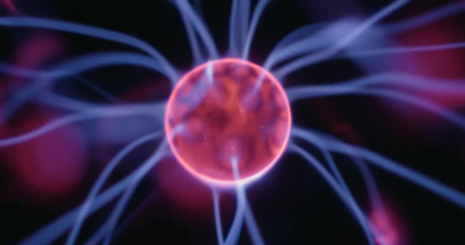 From a stationary vantage a glowing plasma globe releases streaks of electric energy in multiple directions colliding with the globes outer surface while vibrant arcs illuminate the dark backdrop