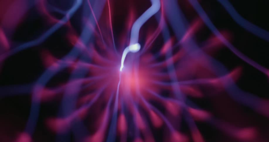 From an interior vantage within a plasma globe a bright energy bolt contacts the outer glass sending purple plasma rippling outward in multiple directions and illuminating the dark backdrop