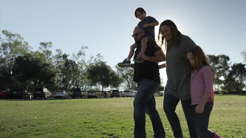 A family walking in the grass