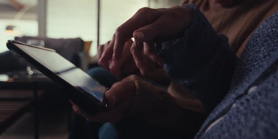 Two people are tapping on the tablet screen