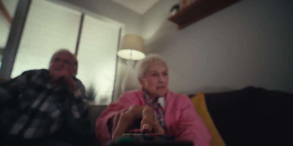 A woman grabs the remote from a man