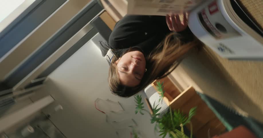 Young woman lying on the carpet reading a book
