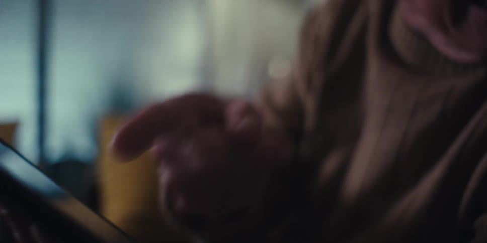 Elderly man pointing finger at a tablet