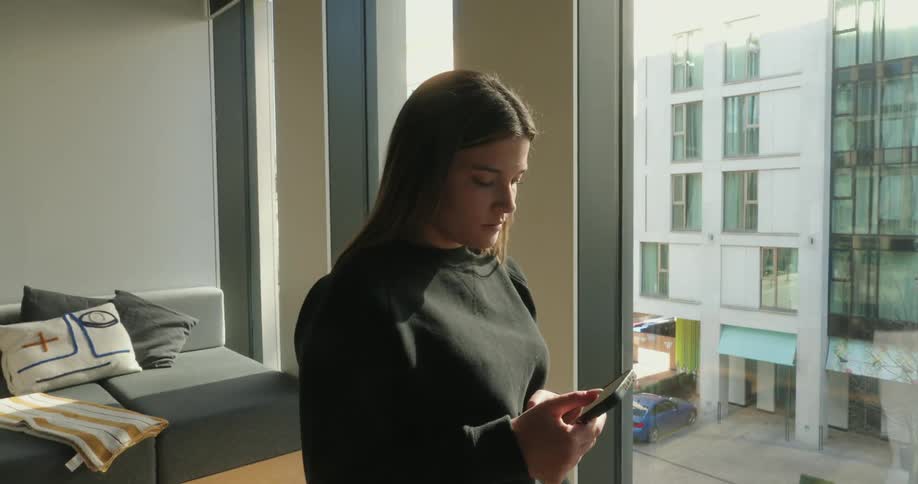 Woman upside down typing on a smartphone