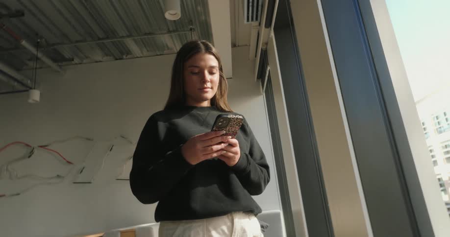 A footage of a lady operating a smart phone