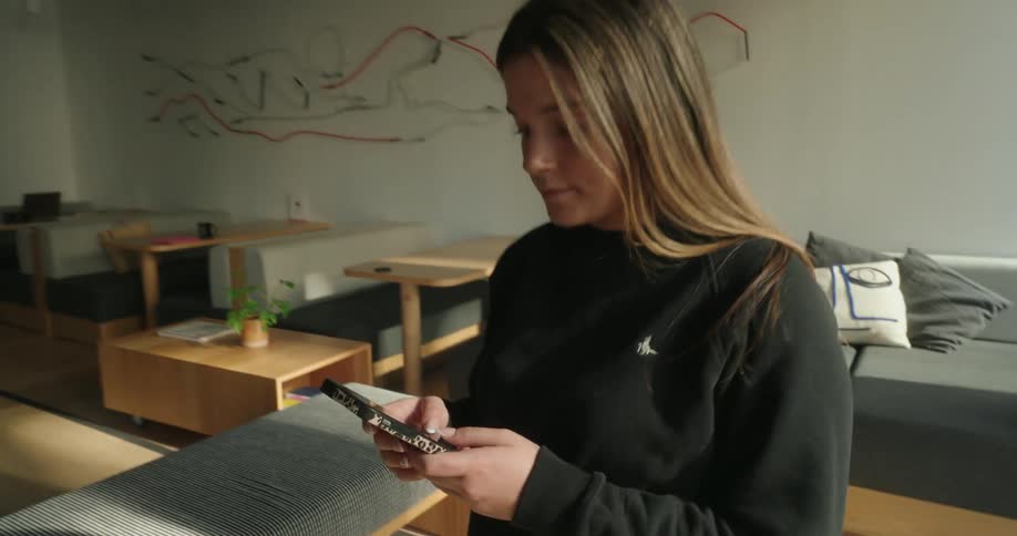 A footage of a girl operating a smartphone