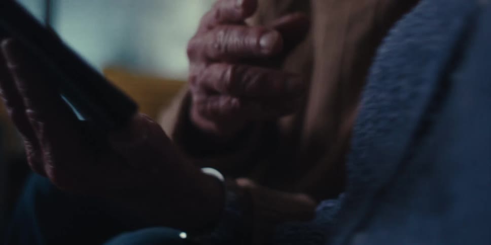Hands of an elderly man holding a tablet