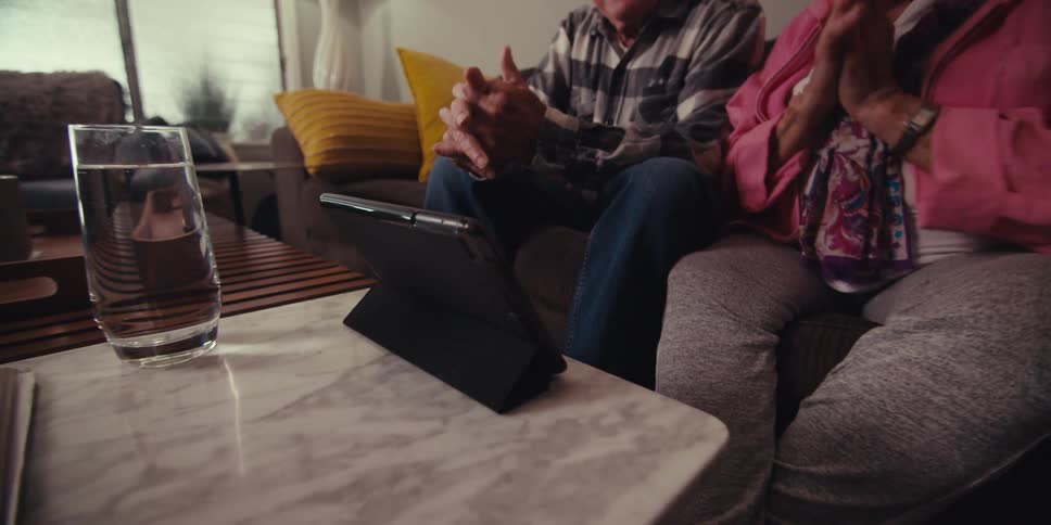An elderly couple in a video call on a tablet