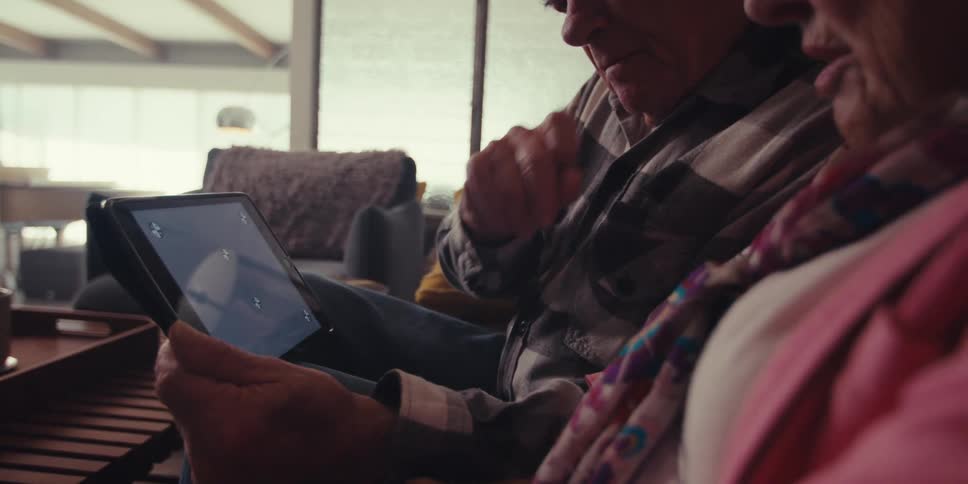 A couple look at the screen and discuss it