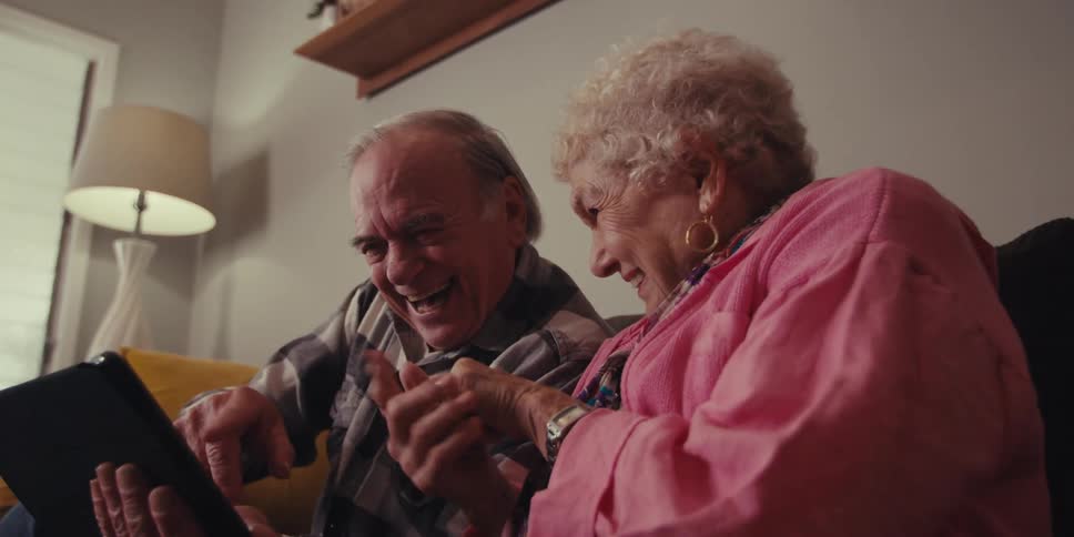 People point and wave at the tablet during a video call