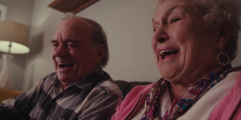 A couple look at each other and laugh