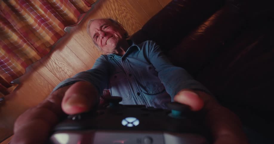 A man twists the joystick as he plays a video game