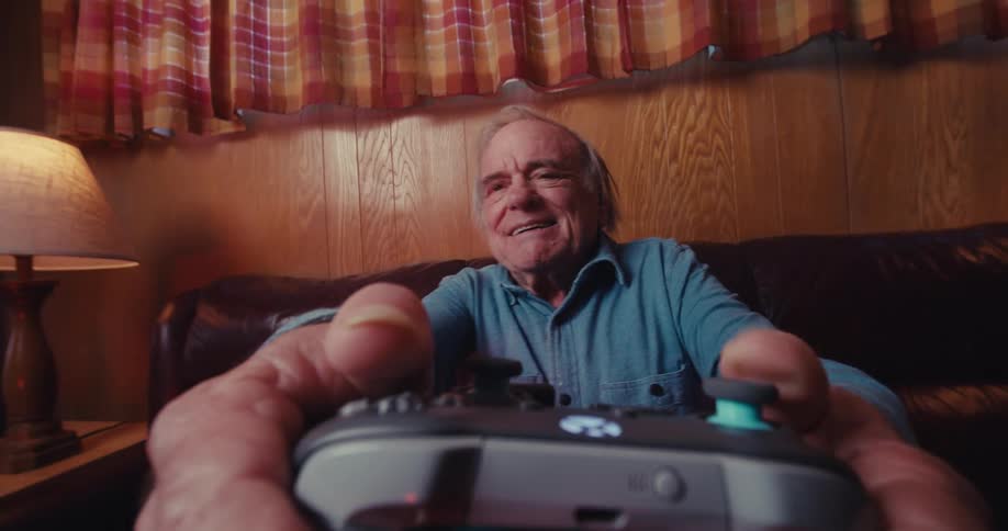 An old man playing an xbox game