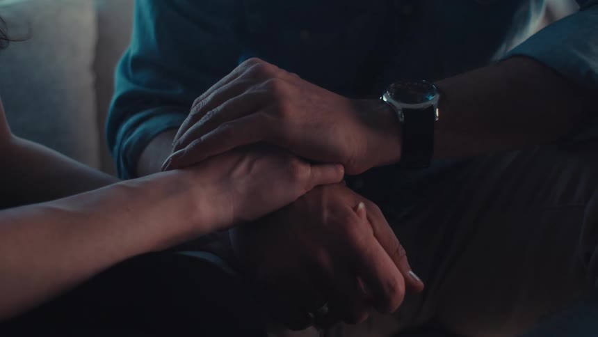 Close up of a couples joined hands