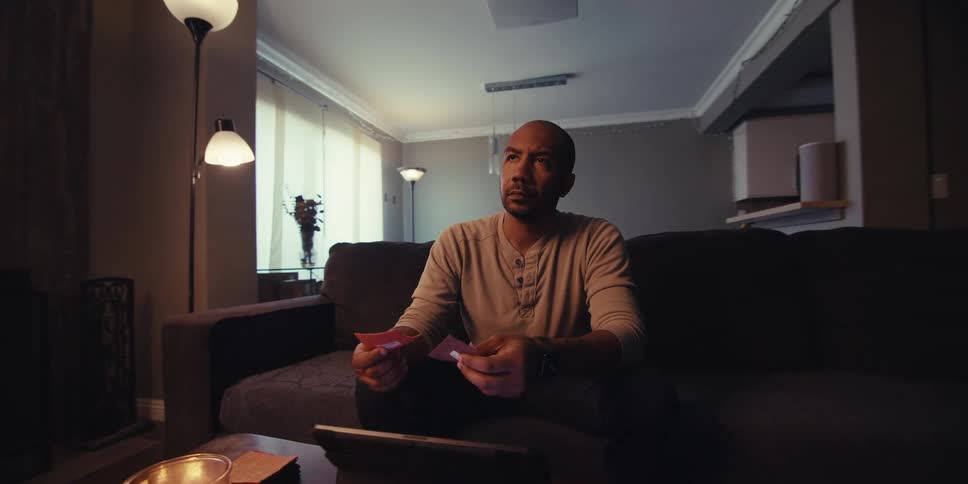 A footage of angry man holding cards