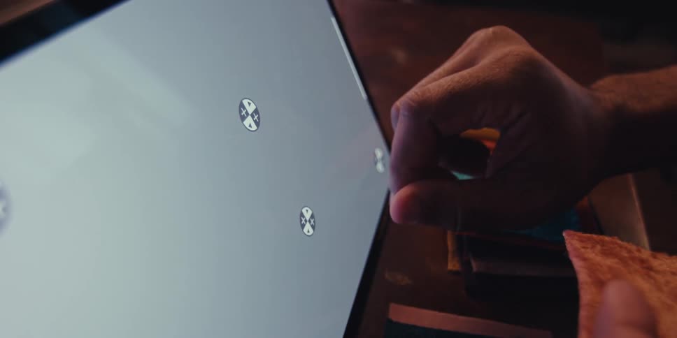 Man interacts with a touchscreen while working on a craft