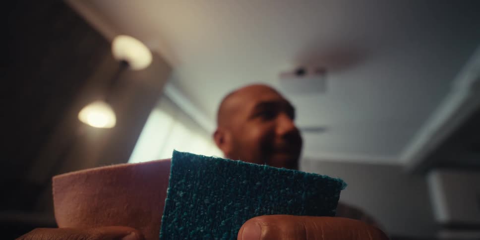 Man holding two fabrics of different colors
