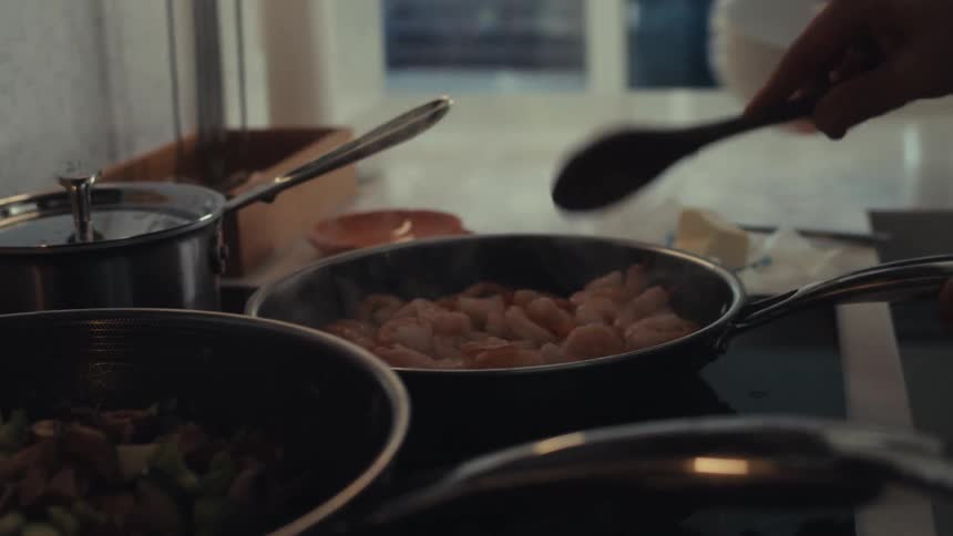 Shrimp is being cooked in a pan