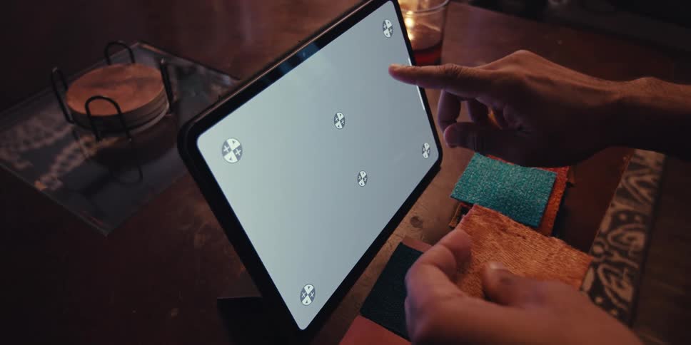 Hand holding a tissue and interacting with a tablet