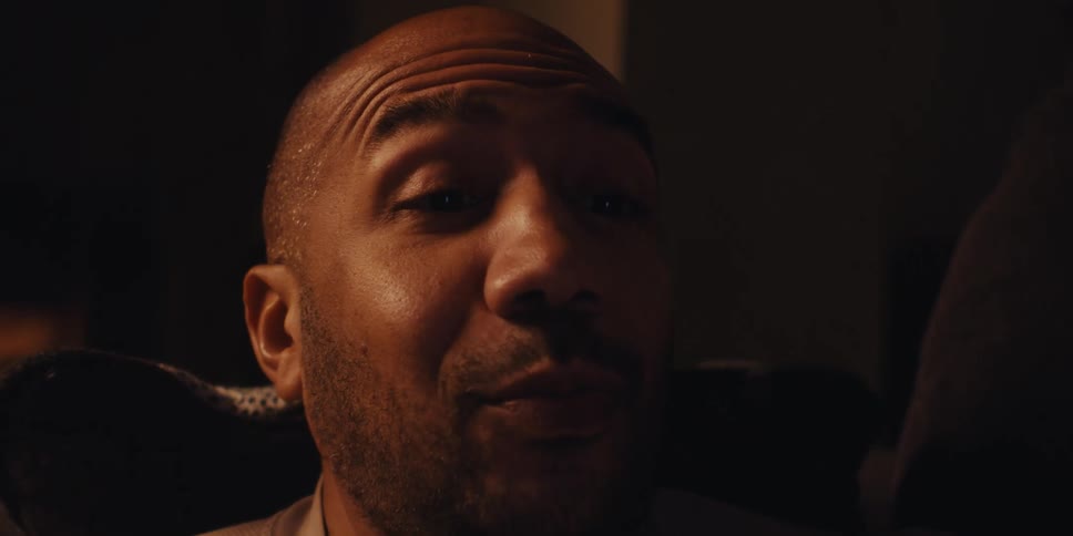 A man is on a video call by the fireplace