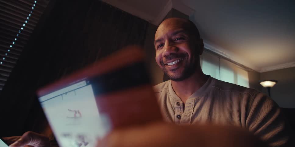 A man nods his head while checking the feed on his phone