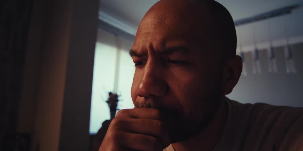 Man typing on a tablet then stops and is thoughtful and surprised