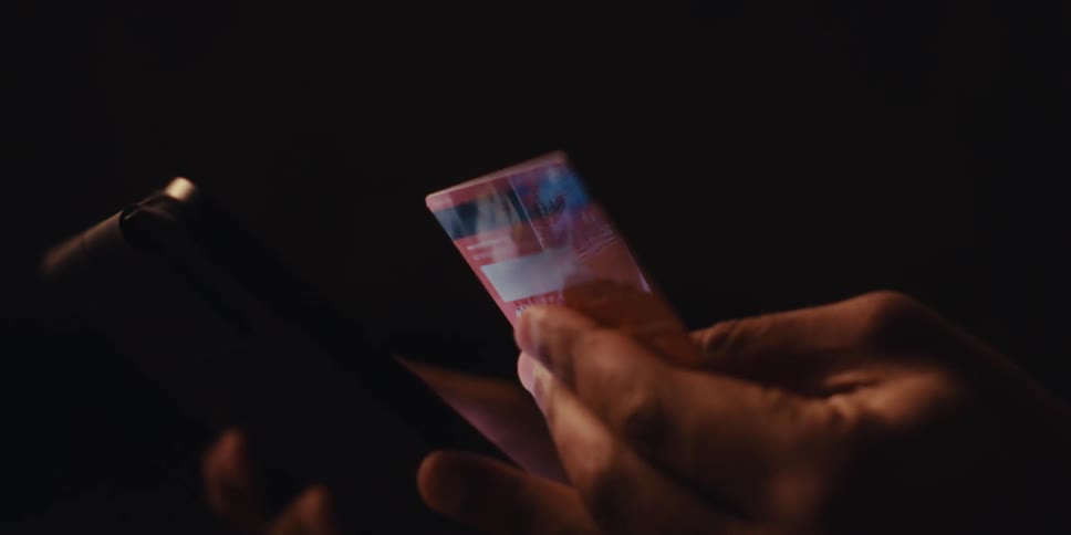 A man is inputting his credit card to make a purchase online