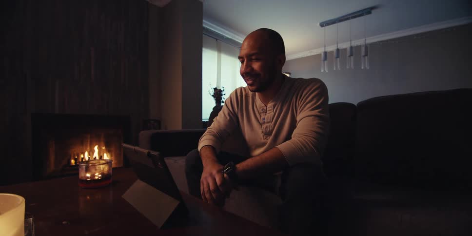 A footage of a man having a video call in the sitting room