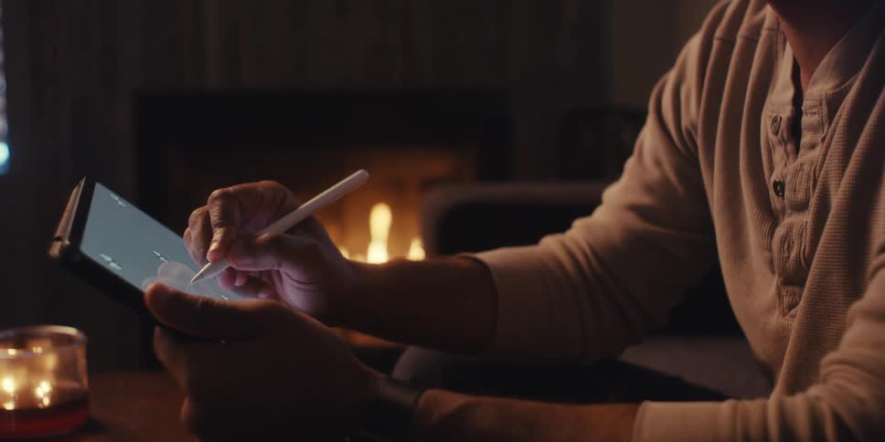 A man uses a stylus on his tablet