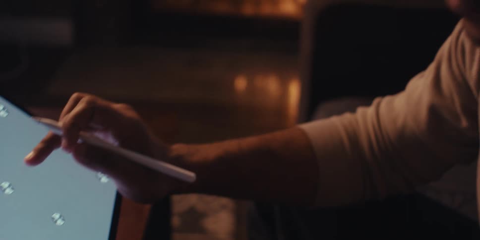 Pair of hands of a man interacting with a tablet