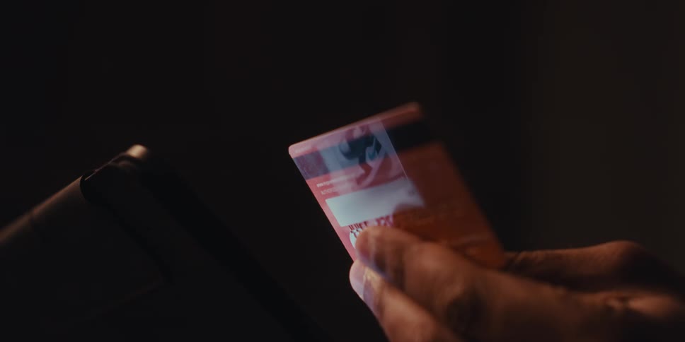 Close up of a hand holding a credit card