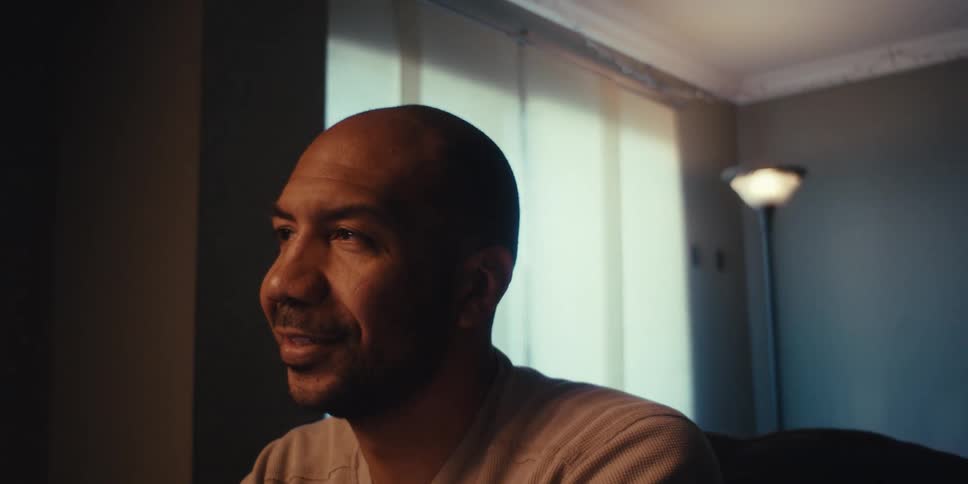 A man smiles in his home